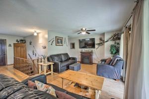 a living room with couches and a table at Lakefront Table Rock Home with Fire Pit! in Golden