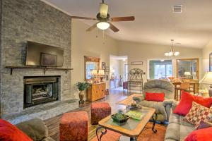 a living room with a fireplace and a tv at Cozy Greenwood Condo with Patio - 2 Mi to Downtown! in Greenwood