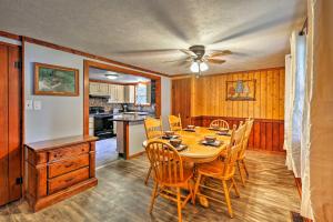a dining room with a table and chairs and a kitchen at Hocking Hills Cabin with Deck, Hot Tub and Pond! in Logan