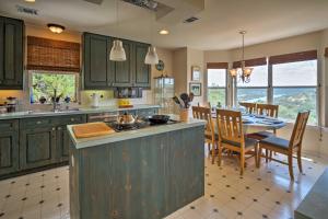 a kitchen with green cabinets and a dining room with a table at 2 Furnished Decks and Lake Views Austin Escape in Austin