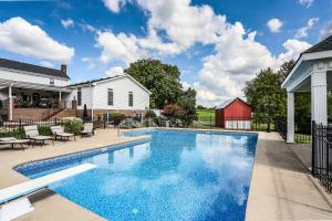 a swimming pool in the backyard of a house at Historic Cedar Hill Mansion on Large Farm with Pool! in Pleasant View