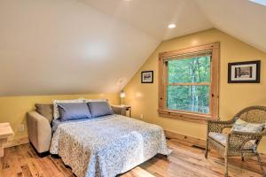 a bedroom with a bed and a window at Romantic Asheville Area Cabin with Deck and Hot Tub! in Leicester