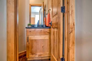 a bathroom with a sink and a wooden cabinet at Modern Moab Townhome with Private Hot Tub and Patio! in Moab +17 photos