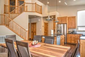 a kitchen and dining room with a wooden table and chairs at Modern Moab Townhome with Private Hot Tub and Patio! in Moab