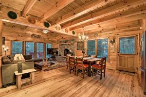 a dining room and living room in a log home at Riverside Ellijay Cabin with Hot Tub and Game Room in Ellijay