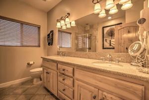 a bathroom with a sink and a toilet and a mirror at Mammoth Lakes Townhome - 10-Min Walk to Village! in Mammoth Lakes +17 photos