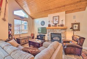 a living room with a couch and a fireplace at Mammoth Lakes Townhome - 10-Min Walk to Village! in Mammoth Lakes