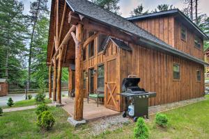 a log cabin with a grill in the front yard at Timber Home Walk to Slopes and N Conway Shops! in North Conway