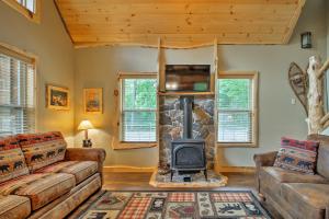 a living room with a couch and a fireplace at Timber Home Walk to Slopes and N Conway Shops! in North Conway