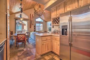 a kitchen with a stainless steel refrigerator and a table at Mammoth Lakes Townhome - 10-Min Walk to Village! in Mammoth Lakes