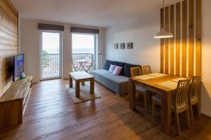 una sala de estar con una mesa y un sofá en Apartment Chamonix PRIMO, en Starý Smokovec
