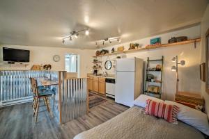 a kitchen with a refrigerator and a table in a room at Cozy Grand Junction Bungalow by Trails and Wineries! in Grand Junction