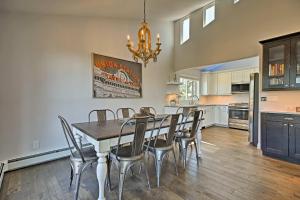 a kitchen and dining room with a table and chairs at Modern Morrison House with Deck and 2 Fireplaces! in Morrison