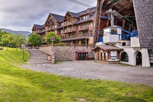 a large building with a stairway leading up to it at Ski-In Resort Family Condo with Deck at Jay Peak! in Jay
