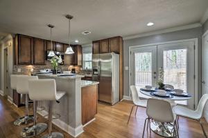 a kitchen with a table and chairs and a refrigerator at Comfortable Ranch Home - 5 Mi to Downtown Atlanta! in Atlanta
