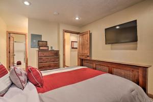 a bedroom with a bed with a television on the wall at Ski-inandSki-Out Brian Head Condo with Hot Tub Access! in Brian Head
