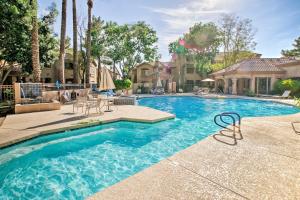 a swimming pool with blue water in a yard at Scottsdale Condo Near Westworld and TPC Golf! in Scottsdale