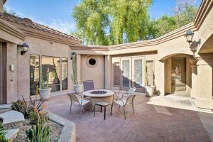 a patio of a house with chairs and a table at Scottsdale Condo Near Westworld and TPC Golf! in Scottsdale