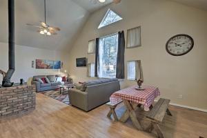 
a living room filled with furniture and a clock at Serene Home Situated in Forest, 4Mi to NAU Campus! in Flagstaff
