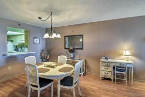 a kitchen and dining room with a table and chairs at Coastal Condo with Balcony Walk to Madeira Beach! in St Pete Beach