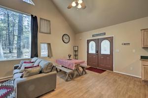 
a living room filled with furniture and a large window at Serene Home Situated in Forest, 4Mi to NAU Campus! in Flagstaff

