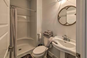 a bathroom with a toilet and a sink and a mirror at Lakefront Studio Guest Home on Hermann Wine Trail! in New Haven