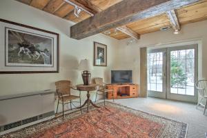 a living room with a table and a tv at Historic Bradford Home - 8 Mi to Mount Sunapee! in Bradford