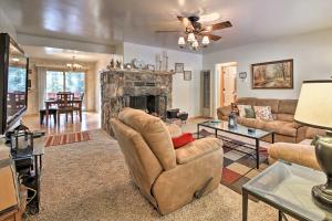 a living room with a couch and a fireplace at Rustic Fawnskin Home with Gas Grill - Walk to Lake! in Fawnskin