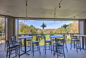 a room with tables and chairs and a large window at Brevard Chalet with Stunning Blue Ridge Mtn Views! in Brevard