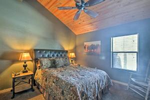 a bedroom with a bed with a ceiling fan at Flagstaff Cabin on 5 Acres with Fireplace and Fire Pit in Flagstaff