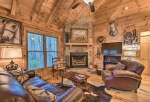 a living room with leather furniture and a fireplace at Cherry Log Cabin 10 Min to EllijayandBlue Ridge! in Cherry Log