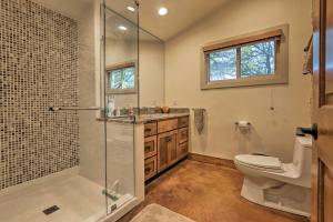 a bathroom with a toilet and a glass shower at Blanco Riverfront Historic Home, 3 Mi to Downtown! in Blanco +19 photos