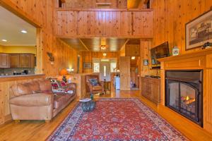 a living room with a couch and a fireplace at Beautiful Bryson City Home with Hot Tub and Mtn Views! in Bryson City