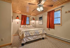 a bedroom with a bed and a ceiling fan at Rustic Cabin in the Woods 6 Mi to Snowshoe Resort in Slaty Fork