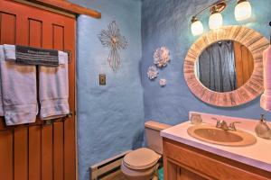 a bathroom with a sink and a mirror at El Prado Adobe Home Courtyard with Mountain Views! in El Prado +19 photos