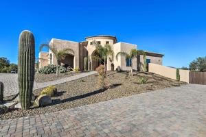 a house with palm trees in front of a driveway at Scottsdale, Rio Verde Getaway Less Than 3 Mi to Golf Club! in Scottsdale
