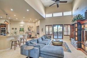 a living room with a blue couch and a kitchen at Scottsdale, Rio Verde Getaway Less Than 3 Mi to Golf Club! in Scottsdale