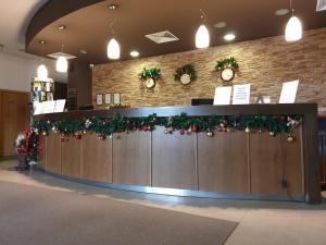 a lobby with christmas wreaths on the wall at Private Studio in Aspen Golf and Ski Resort in Razlog