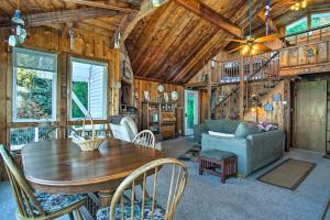 a living room with a table and a couch at Lakefront Montague Cottage with Deck and Beach! in Rothbury