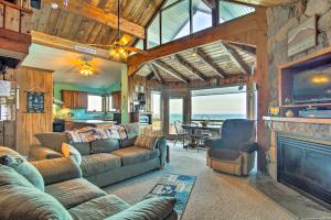 a living room with couches and a fireplace at Lakefront Montague Cottage with Deck and Beach! in Rothbury