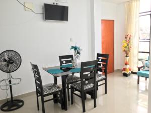 a dining room with a table and chairs at Departamentos Boulangger in Zorritos