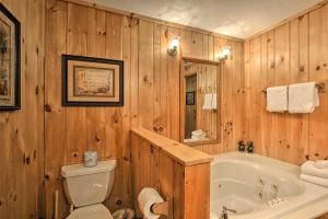 bagno in legno con vasca e servizi igienici di Private Gatlinburg Cabin Pet Friendly with Hot Tub! a Gatlinburg Altre 16 foto