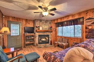a living room with a couch and a fireplace at Private Gatlinburg Cabin Pet Friendly with Hot Tub! in Gatlinburg