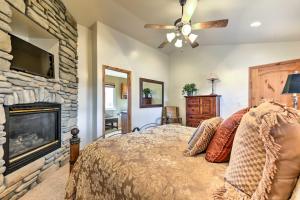 a bedroom with a bed and a stone fireplace at Eden Townhome with Mtn View and Shuttle to Powder Mtn! in Eden