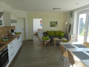 a kitchen and living room with a couch and a table at Komfort Ferienwohnung Wolfhagen in Wolfhagen +15 photos