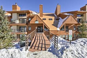 a home in the snow with a staircase leading to it at 10 Mi to Keystone Updated Mtn-View Condo in Silverthorne