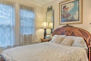 a bedroom with a large bed and two windows at Historic Ocean Grove Home - Walk to Beach! in Ocean Grove