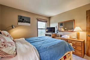 a bedroom with a bed and a mirror and a television at 10 Mi to Keystone Updated Mtn-View Condo in Silverthorne