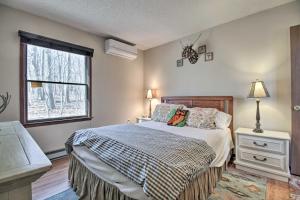 a bedroom with a large bed and a window at Cozy Wintergreen Cabin Near Mountain Inn and Slopes! in Wintergreen