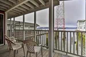 a porch with chairs and a view of the water at Sleek Riverfront Condo on Pier in Downtown Astoria in Astoria, Oregon